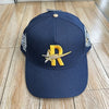 Navy baseball cap embroidered with a gold letter R and silver star design