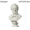 A white plaster bust miniature of a man, likely a classical figure, displayed on a pedestal.