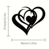 Black metal wall art featuring two intertwined heart shapes.