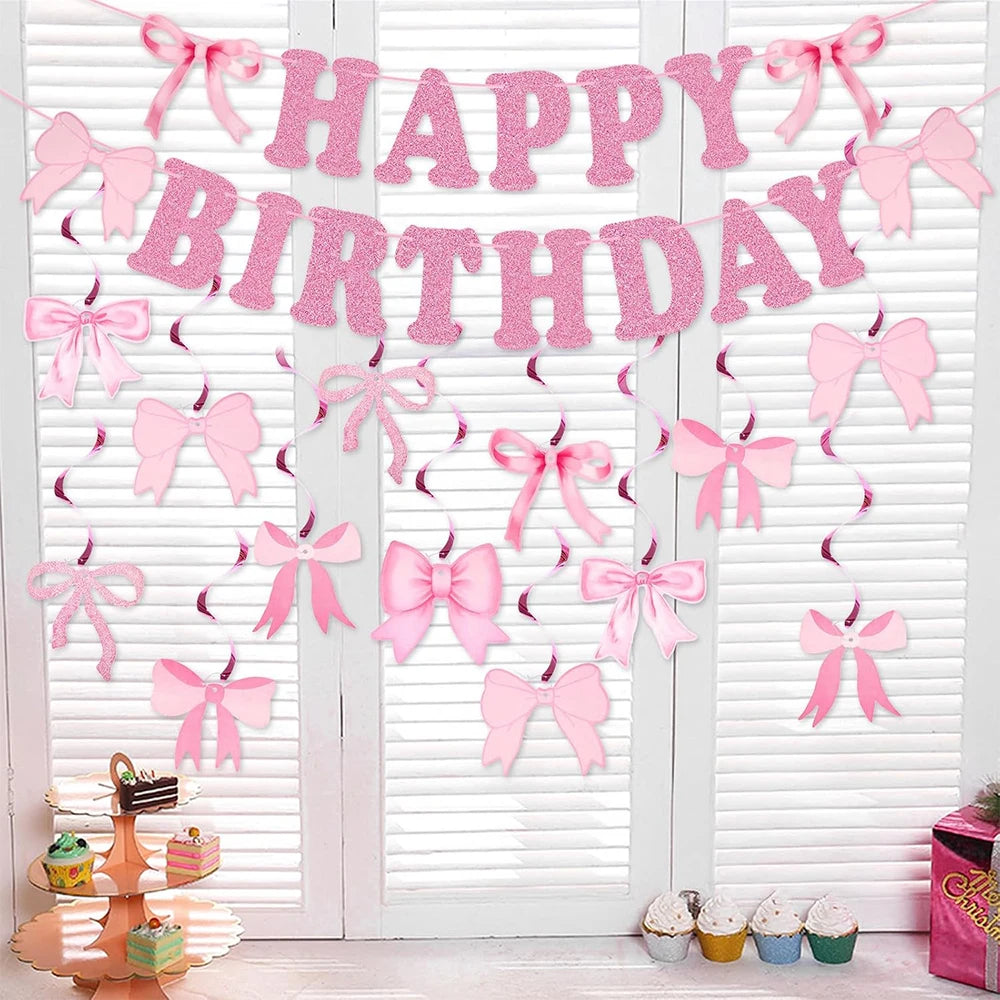 Glitter pink bow birthday banner strung across a white slatted door.