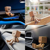 Handmade wooden shaking figure with magnetic expressions displayed in various automotive contexts.