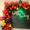 A vibrant arrangement of red, black, and gold star burst foil balloons used for party decor.