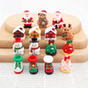 A set of festive Christmas resin decor featuring Santa figures, reindeer, and holiday ornaments.