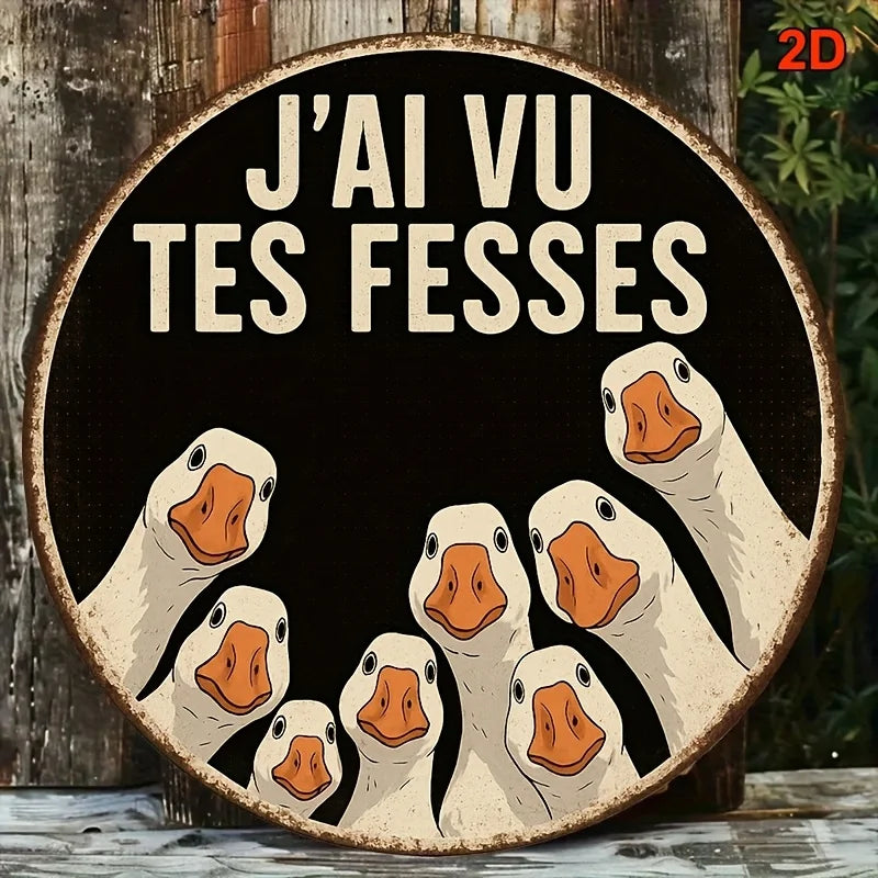 A round wooden sign featuring a humorous illustration of several white ducks with orange beaks against a black background.