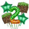 A set of green and gold miner-themed birthday party supplies including balloons and tableware.