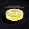 A round, translucent yellow citrine crystal bowl with natural inclusions, shown against a dark background.