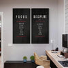 Two framed motivational canvas prints titled FOCUS and DISCIPLINE displayed on a white wall.