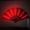 A red illuminated folding hand fan with LED lights displayed against a dark background.