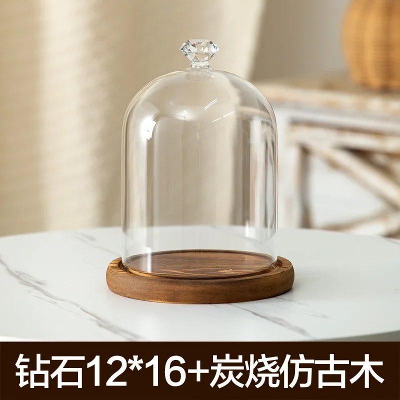 Glass aromatherapy candle holder with a clear dome and a wooden base
