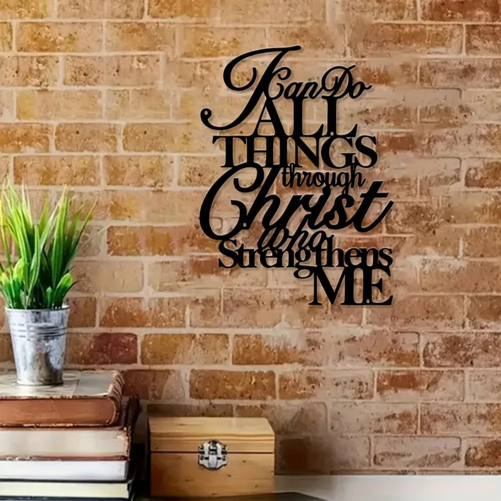 Black script wall art on a brick background featuring the verse "God do all things through Christ who strengthens me"