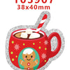 A red mug filled with hot chocolate and topped with whipped cream, surrounded by silver glitter acrylic charms.