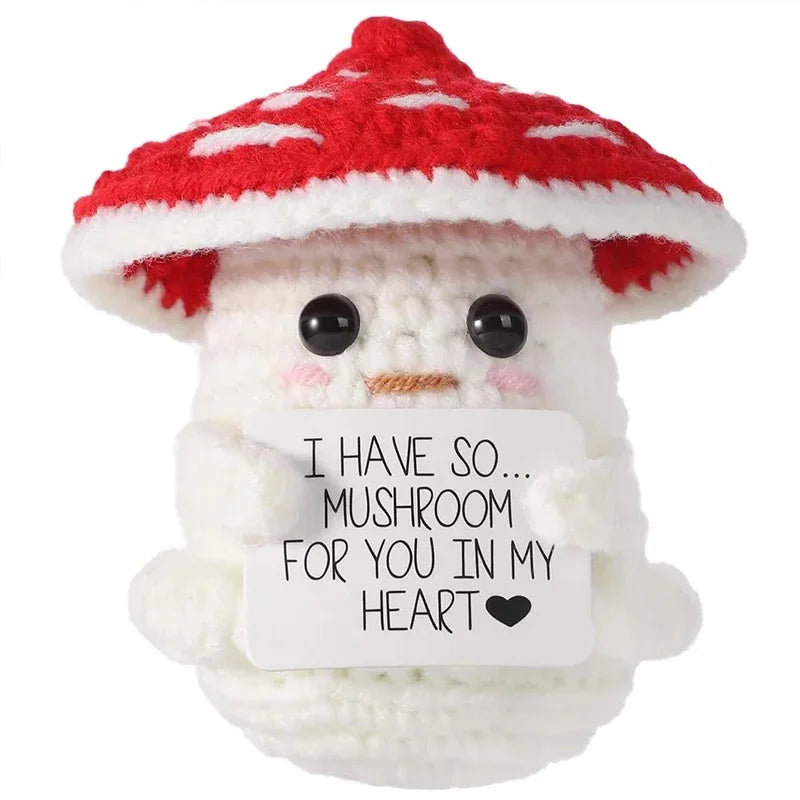 A white crochet animal doll with a red mushroom cap and a message card that reads I have so mushroom for you in my heart