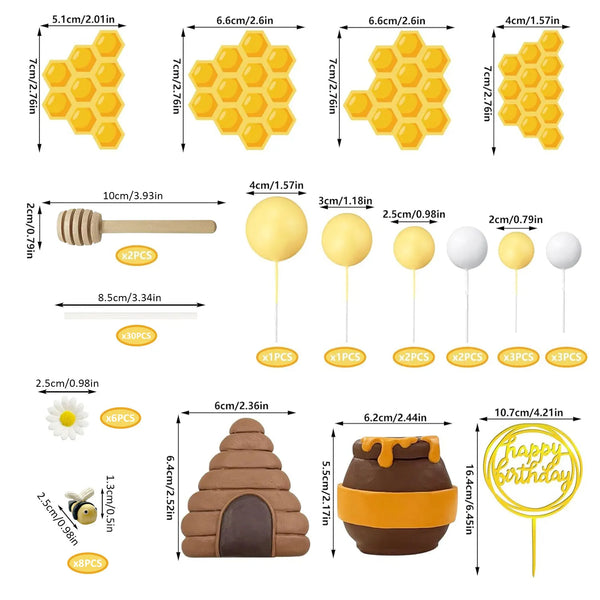 A set of bee-themed cake toppers including honeycomb decor, a honey jar, and various yellow and brown shapes.
