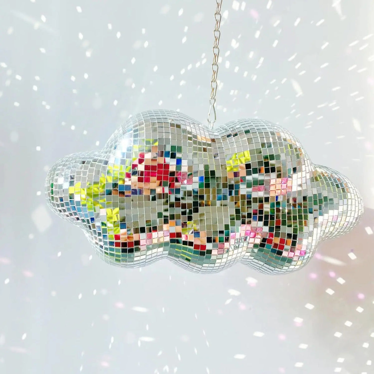 A hanging ornament shaped like a cloud, made of multicolored mosaic glass pieces.