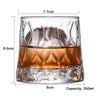 A clear whiskey glass with a heavy base, showing liquid and dimensions.