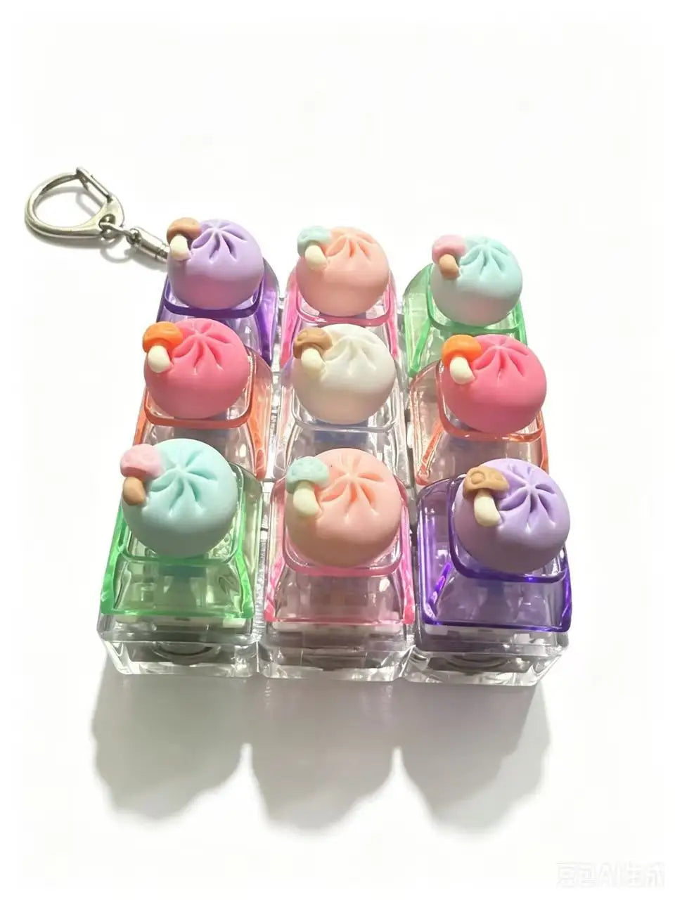 Un set de llaveros de teclado para hacer fidget con dumplings táctiles y argolla metálica.