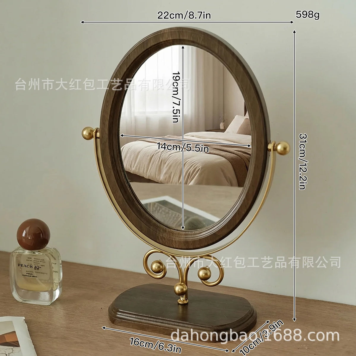 A round, gold-framed oval vanity mirror with a wooden base and a reflective surface.