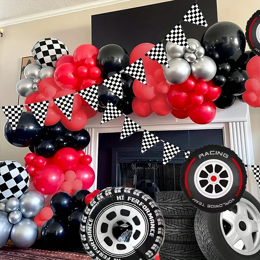 A balloon garland arch featuring red, black, and silver balloons with checker tire accents.