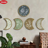 A set of five natural wood and white floral moon phase wall decorations mounted on a light gray wall.