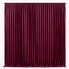 A floor-to-ceiling deep burgundy velvet curtain backdrop for events