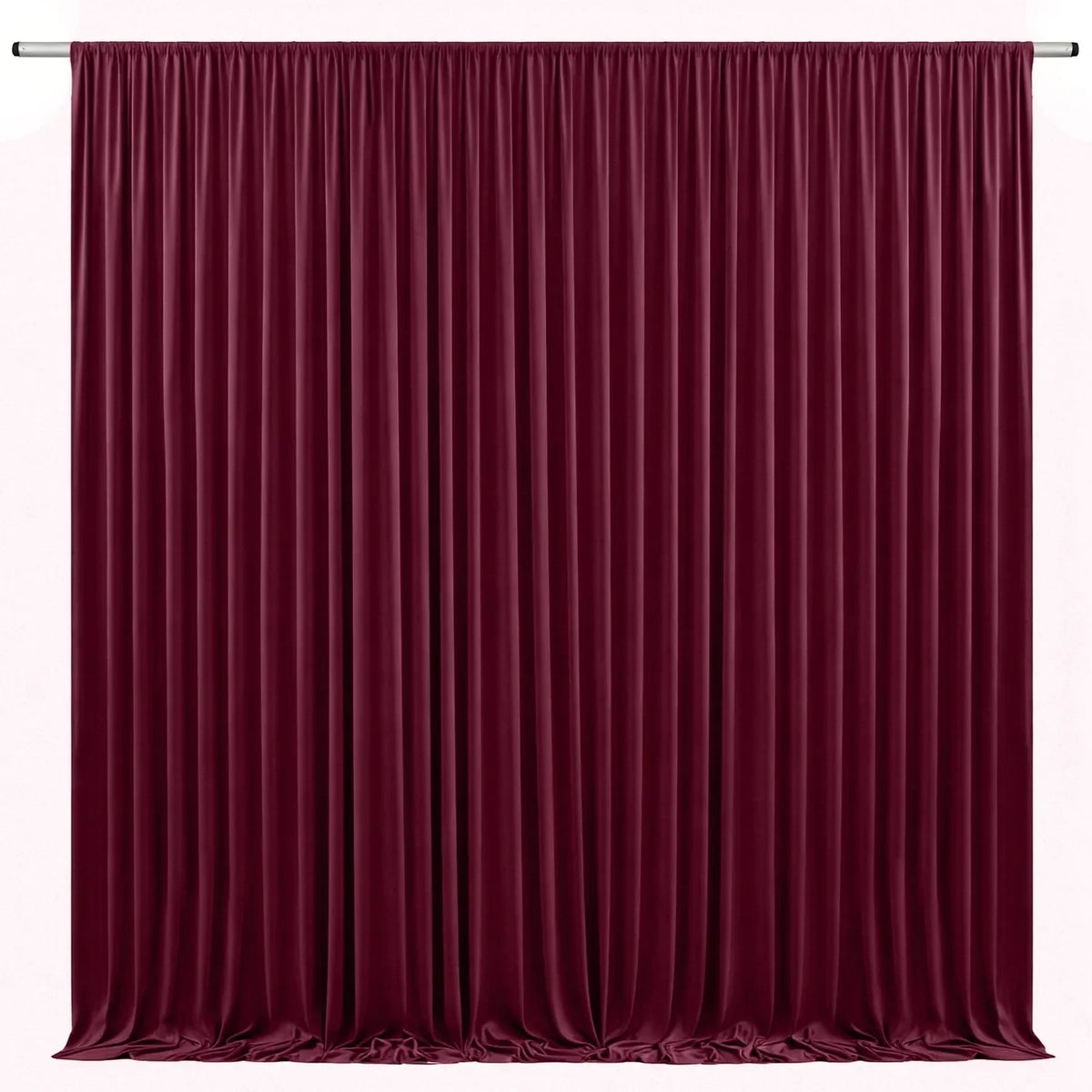 A floor-to-ceiling deep burgundy velvet curtain backdrop for events