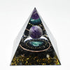 Handmade resin orgonite pyramid featuring natural obsidian and a copper coil.