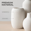 A set of three white ceramic vases with a vertical ribbed texture, showcasing premium material and matte finish.