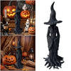 Estatua de bruja oscura y texturizada con sombrero puntiagudo y cabello flotante, exhibida en decoración de Halloween.