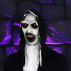 A realistic horror nun latex mask with pale white face, dark eyes, and a black hood against a purple background.