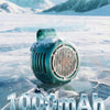 A teal portable bladeless clip-on fan rests on a frozen ice surface with snowy mountains in the background.