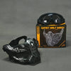 A black tactical silicone half-face mask is displayed next to a pair of black goggles and its packaging.