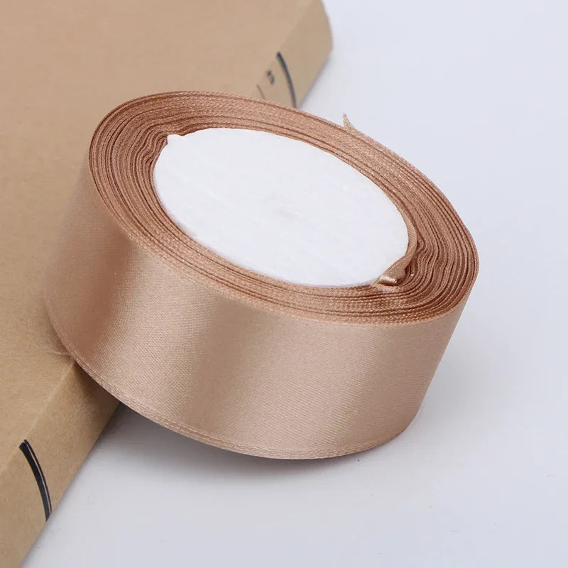Roll of satin ribbon in beige color for crafts and gift wrapping