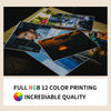 A collection of diverse photographic prints displayed on a wooden surface.