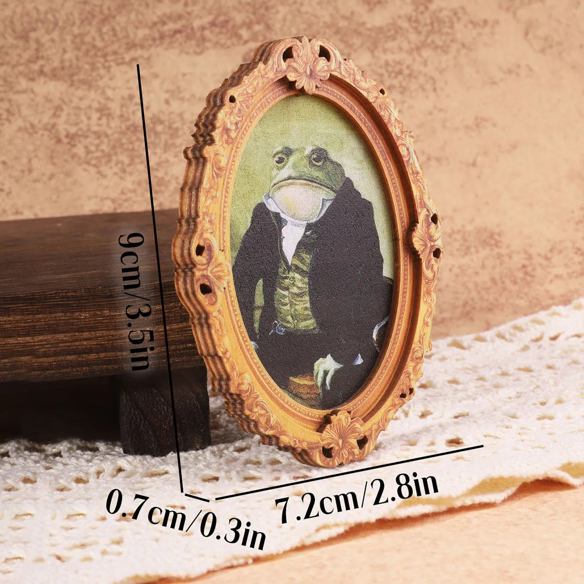 Vintage gentleman frog wooden frame magnet with gold accents displayed on a wooden surface.