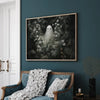 Vintage spooky canvas wall art featuring a white ghost and pumpkin print displayed on a dark teal wall.