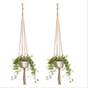 Handmade macrame plant hanger with a woven basket suspended by cotton rope for home and garden use