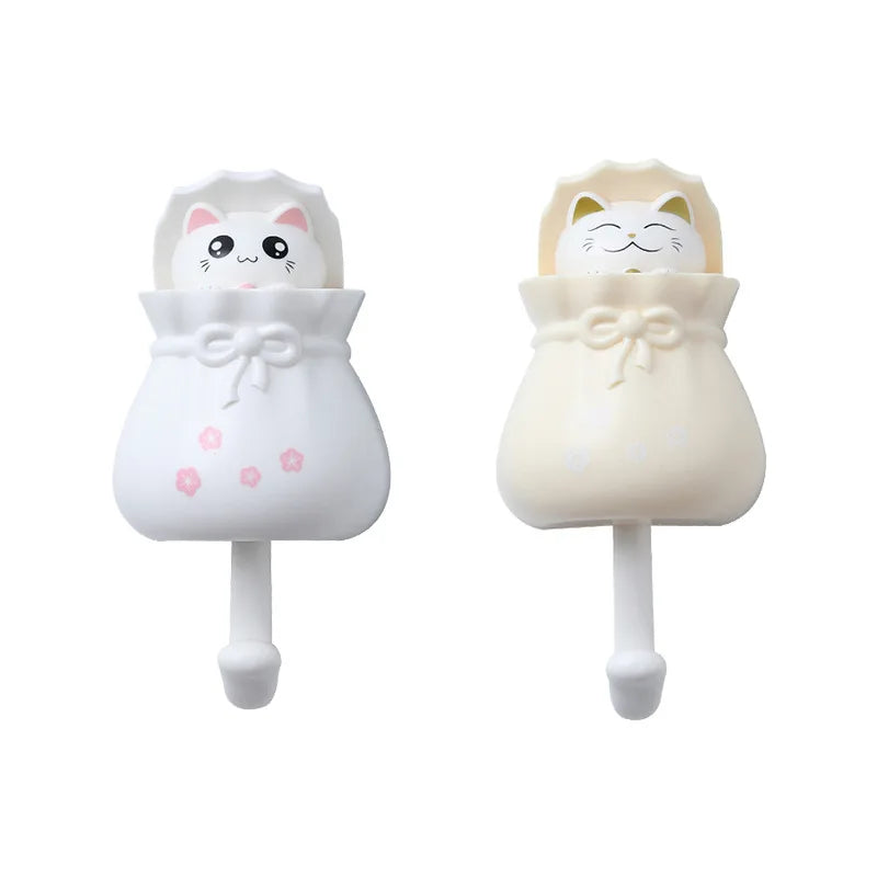 White cartoon cat wall hooks with a bow detail for organization