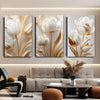 A set of three modern 3D floral canvas wall art pieces featuring white and gold lotus flowers displayed on a light gray wall.