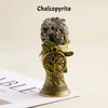A natural crystal chalcopyrite mineral mounted on a brass bell with a copper finish.
