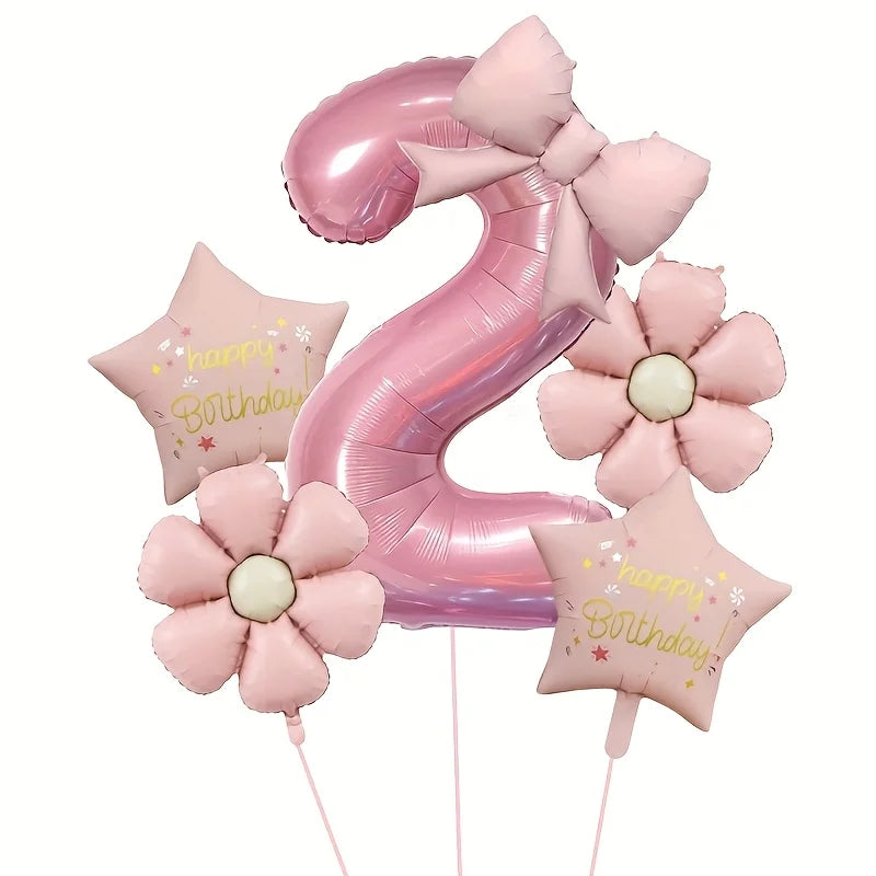 Pink foil balloons shaped like the number nine and flowers for a birthday celebration