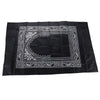 Black prayer mat with an ornate white border design and a compass shape.