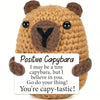 A hand-woven brown capybara plush pendant with an encouraging card that reads I believe in you and you're capy-tastic