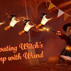 A witch with flowing hair and a hat holds a magic wand, surrounded by floating LED candles.