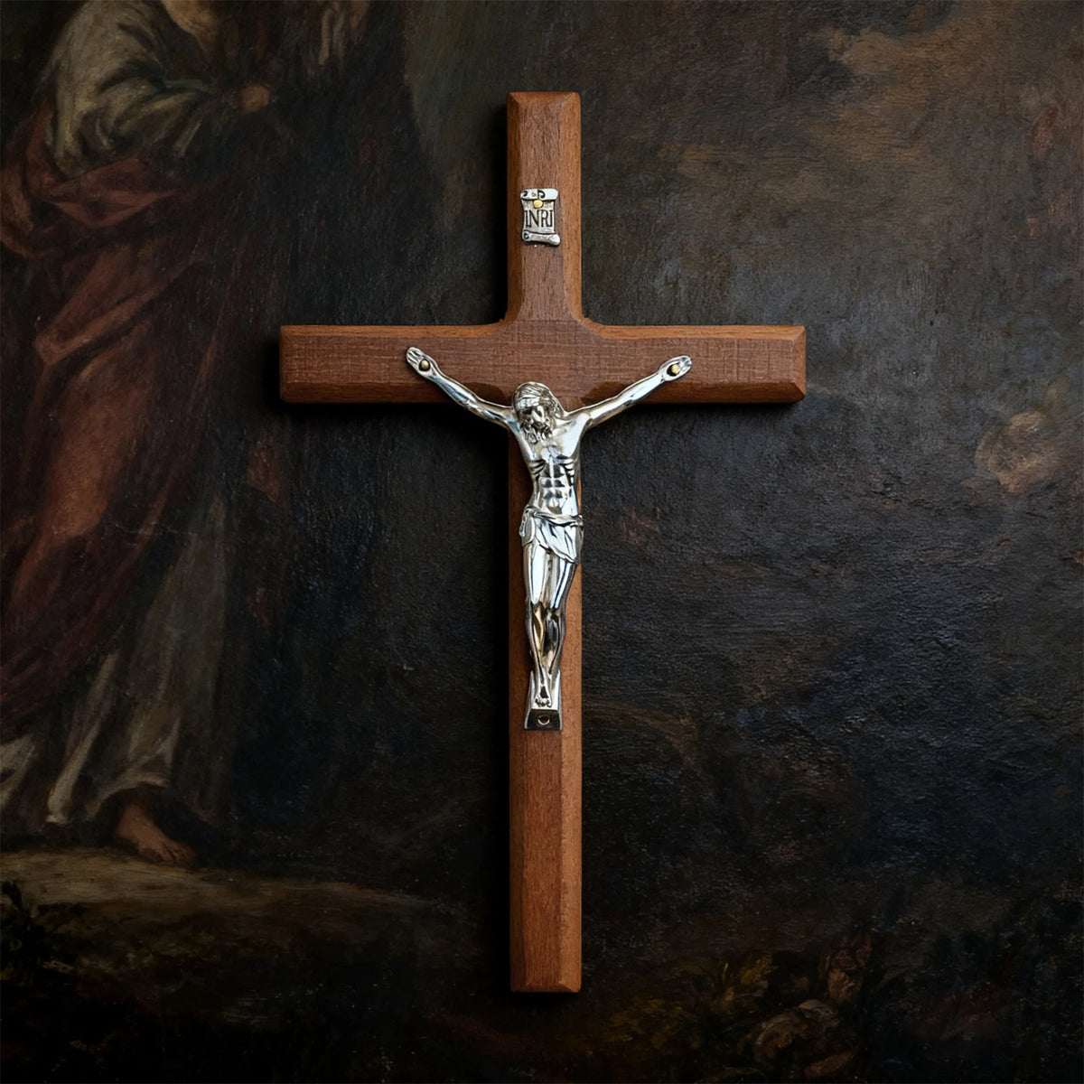 A hand-carved wooden cross with a silver crucifix mounted on a dark background.