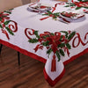 White rectangle tablecloth with a red and green poinsettia pattern and ribbon accents.