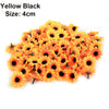 A pile of yellow black artificial sunflower and daisy heads, size 4cm.