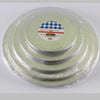 A set of round green cake boards wrapped in plastic, with one board featuring a blue and white checkered pattern.