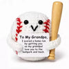 Handmade crochet baseball bat doll with a smiling face and a card