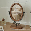 An oval vanity mirror with a wooden frame and stand, showing dimensions and weight.