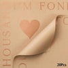 A close-up of light peach waterproof floral wrapping paper with a heart design and text on the side.